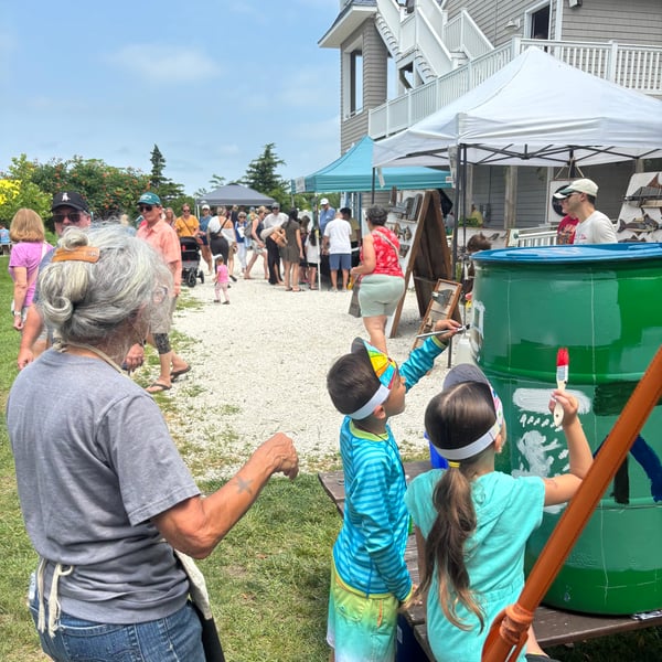 Carol and kids working on a rain barrel