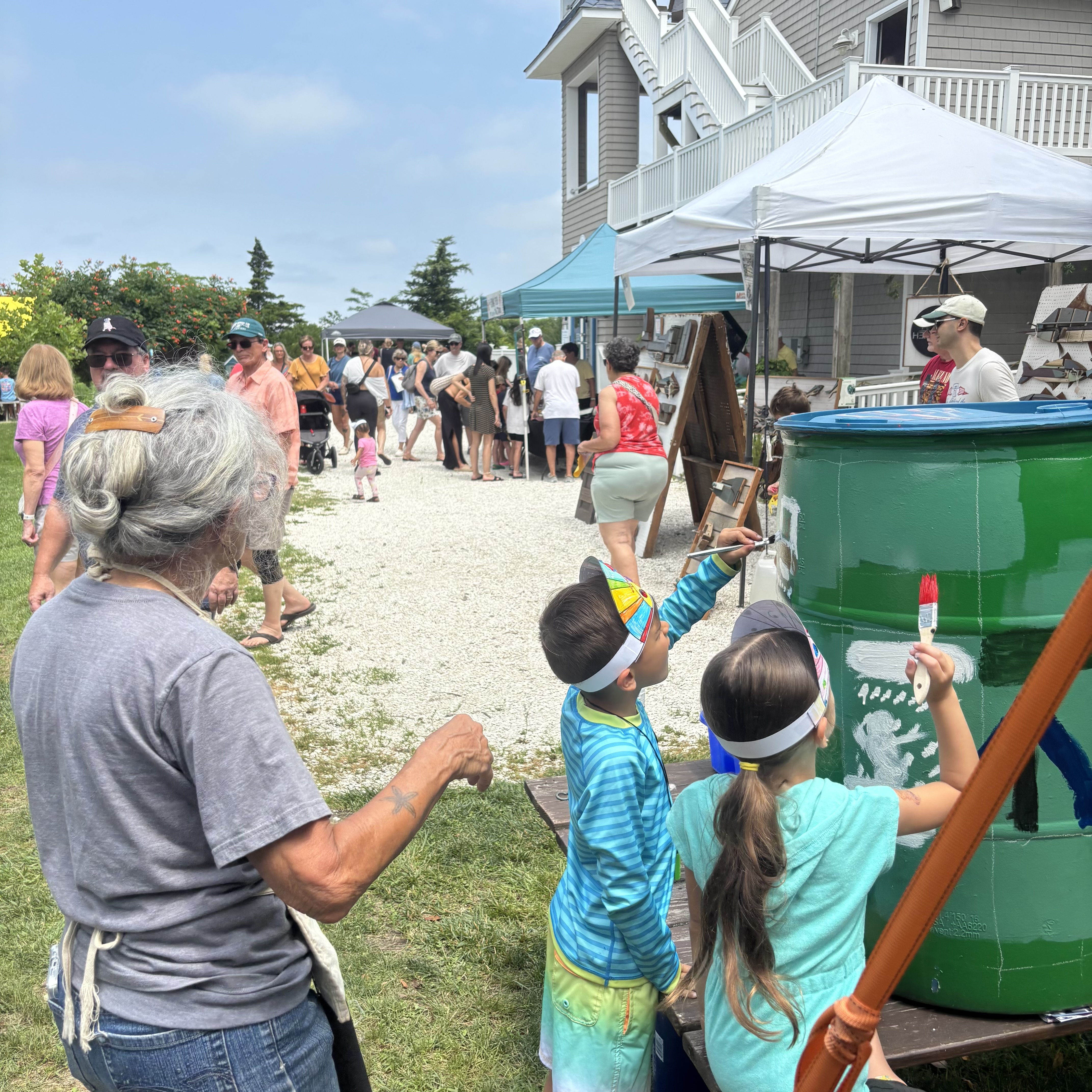 Carol and kids working on a rain barrel 